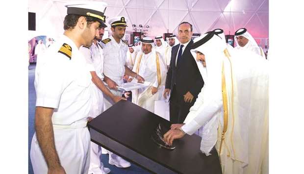 His Highness the Emir Sheikh Tamim bin Hamad al-Thani places the logo of Hamad Port marking the official inauguration of the $7.4bn maritime facility located in the Umm Al Houl area south of Doha.