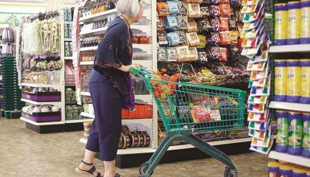 A customer pushes a shopping cart down an aisle at a Dollar Tree store in Louisville, Kentucky. The US Commerce Department said retail sales edged up 0.1% last month, the smallest rise since February.