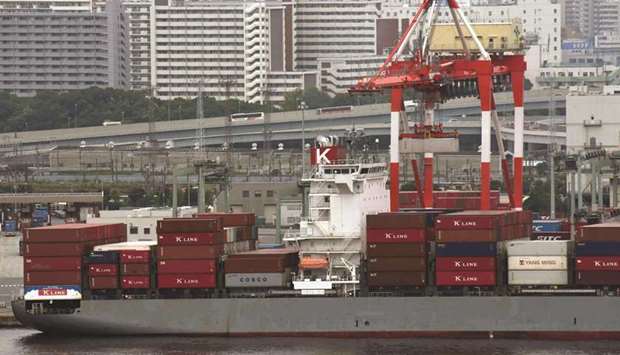 A freighter is anchored at the international container pier at Tokyo port. Japanu2019s exports are seen rising 5.6% in August from a year earlier, the poll of 16 economists found, after a gain of 3.9% in July.