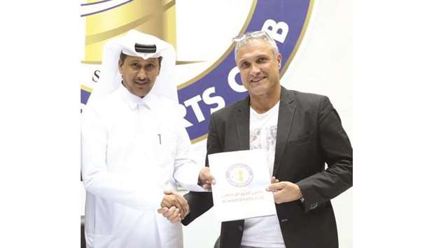 French manager Bernard Casoni (right) with Al Khor Sports Club president Hassan Juma al-Mohannadi.