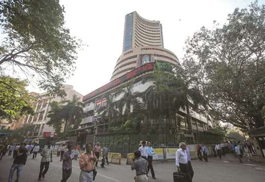 People walk by the Bombay Stock Exchange building in Mumbai (file). The Sensex trades at an estimated price-earnings ratio of about 21, the steepest among equity benchmarks in the region after New Zealand.