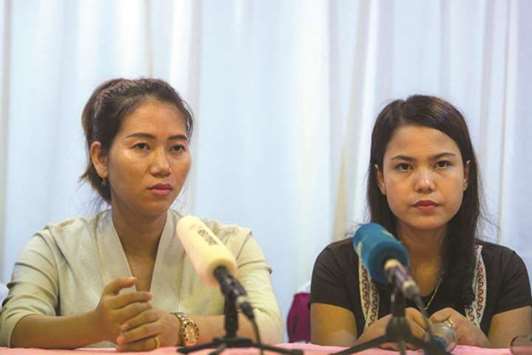 Pan Ei Mon, left, and Chit Su Win, wives of detained Reuters journalists Wa Lone and Kyaw Soe Oo, attend a press conference in Yangon yesterday.