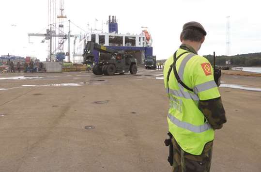 A Norwegian soldier stands guard as a German military vehicle is unloaded at Fredrikstad, Norway.