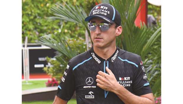 Robert Kubica arrives at the paddock of the Formula One Singapore Grand Prix at the Marina Bay Street Circuit in Singapore yesterday.