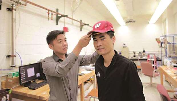 Professor Xudong Wang (left) and colleagues developed a device - unobtrusive enough to fit under a cap - that harnesses energy from the wearer and delivers gentle electric pulses to stimulate dormant hair follicles and regrow hair.