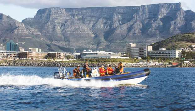 Tourists on a boat ride with South Africau2019s 260mn year-old Table Mountain u2013 voted as one of the New 7 Natural Wonders of the World u2013 on the background. PICTURES: SATB