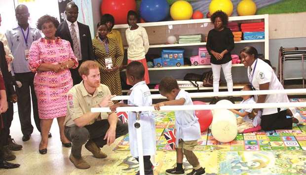 Harry with staff and patients at the Princess Diana Orthopaedic Centre in Huambo, Angola, on Friday.