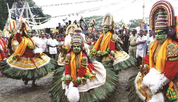 Artists perform on a street as they participate in a programme to herald the beginning of the ten-day harvest festival of Onam in Thripunithura, near Kochi, yesterday.