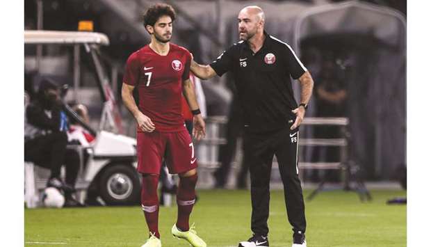 Qataru2019s coach Felix Sanchez (R) talks to his forward Ahmed Alaaeldin on the sideline  during the teamu2019s match against Afghanistan at the Jassim bin Hamad Stadium  in Doha on Thursday.