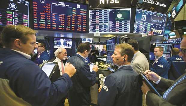 Traders work on the floor of the New York Stock Exchange (file). After the S&P 500 suffered its first monthly drop since May, in part because the Treasury curve inversion is seen by many as a harbinger of recession, equities have gotten off to a solid start in September, historically their worst month of the year.