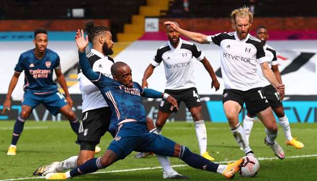 Alexandre Lacazette stretches for the ball during the English Premier League match.