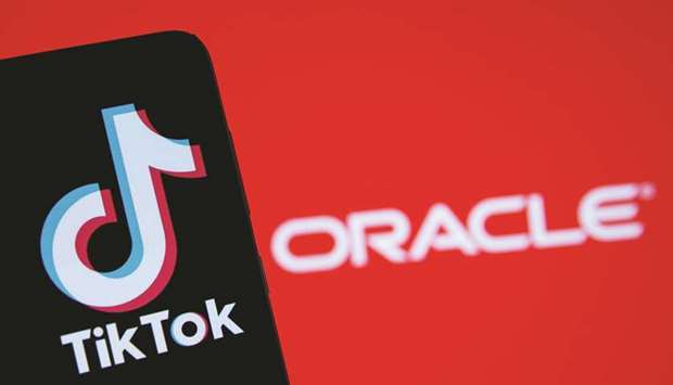 A smartphone with the Tik Tok logo is seen in front of a displayed Oracle logo in this illustration taken yesterday. Oracle beat Microsoft in the battle for the US arm of TikTok with a deal structured as a partnership rather than an outright sale to try to navigate geopolitical tensions between Beijing and Washington, people familiar with the matter have said.