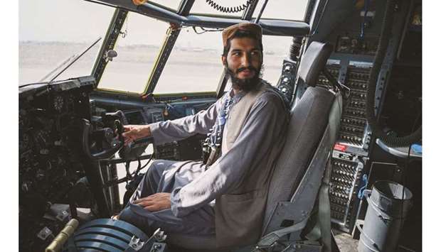 A Taliban fighter sits in the cockpit of an Afghan Air Force aircraft at the airport in Kabul yesterday after the US has pulled all its troops out of the country.