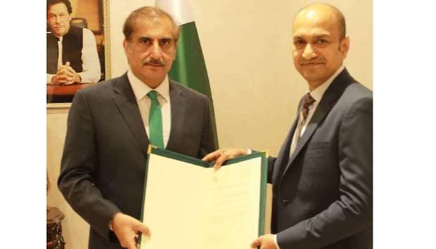 Ambassador Syed Ahsan Raza Shah hands over the appointment letter to Mohsin Mujtaba