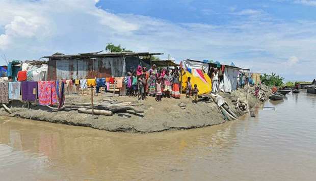 Villagers take shelter on higher ground after incessant rain flooded India's Assam state. (AFP)