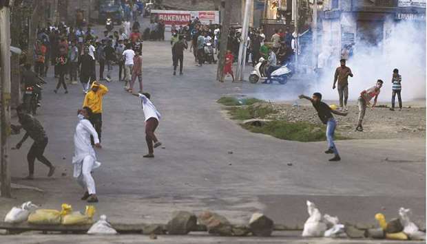 Kashmiri protesters pelt stones at security forces during a clash in Srinagar yesterday after authorities imposed a lockdown across the region following the death of Syed Ali Shah Geelani.