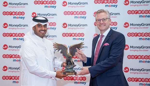 Alex Holmes, CEO and chairman at MoneyGram, and Sheikh Nasser bin Hamad bin Nasser al-Thani, chief commercial officer at Ooredoo, at a ceremony held at Ooredoo Tower.