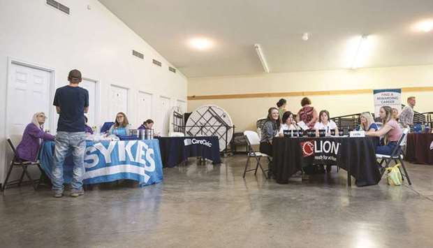 Job seekers speak with recruiters during a job fair at a community centre in Beattyville, Kentucky. The number of Americans filing new claims for jobless benefits fell last week, while layoffs dropped to their lowest level in more than 24 years in August, suggesting the labour market was charging ahead even as new Covid-19 infections surge.