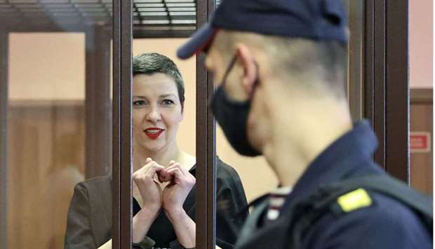 Maria Kolesnikova gestures from inside the defendantsu2019 cage during her verdict hearing on charges of undermining national security, conspiring to seize power, and creating an extremist group, in Minsk.