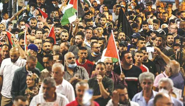 Demonstrators take part in a rally in support of Palestinian prisoners held in Israeli jails, in the West Bank city of Ramallah, yesterday.