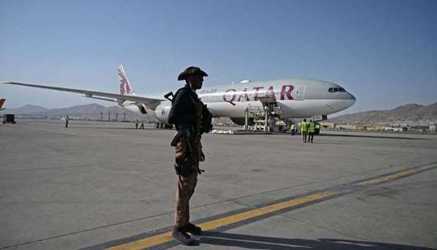 A Qatari security personnel stands guard near a Qatar Airways aircraft at the airport in Kabul on September 9, 2021.