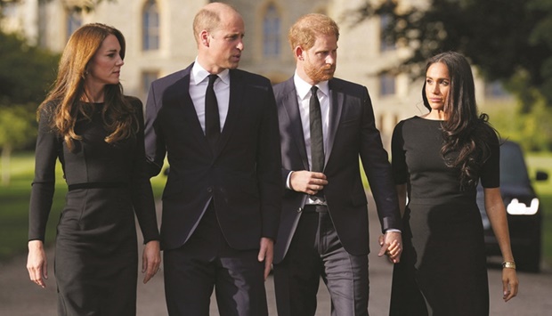 Britainu2019s William, Prince of Wales, Kate, Princess of Wales, Prince Harry and Meghan, walk to meet members of the public at Windsor Castle, following the passing of Queen Elizabeth, in Windsor, yesterday.