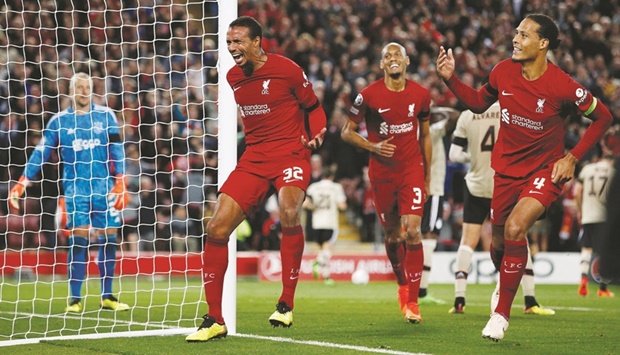 Liverpoolu2019s Joel Matip (left) celebrates with teammates Virgil van Dijk (right) and Fabinho after scoring against Ajax during the Champions League Group A match at Anfield in Liverpool on Tuesday night. (Reuters)