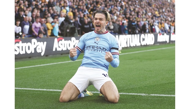 Manchester Cityu2019s Jack Grealish celebrates after scoring against Wolverhampton Wanderers during the Premier League match at the Molineux Stadium in Wolverhampton yesterday. (Reuters)