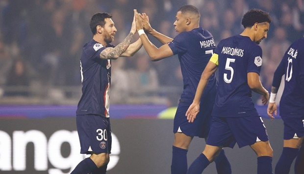 PSGu2019s Lionel Messi (left) is congratulated by teammate Kylian Mbappe after scoring a goal during the French Ligue 1 match against Olympique Lyonnais at the Groupama Stadium in Decines-Charpieu, France. (Reuters)