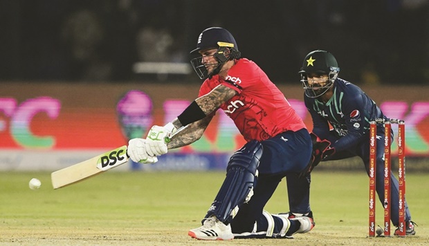 Englandu2019s Alex Hales plays a shot as Pakistanu2019s wicketkeeper Mohamed Rizwan watches during the first Twenty20 international at the National Cricket Stadium in Karachi yesterday. (AFP)