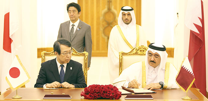 HE the Prime Minister and Minister of the Interior Sheikh Abdullah bin Nasser bin Khalifa al-Thani and Abe witness the signing of an agreement.
