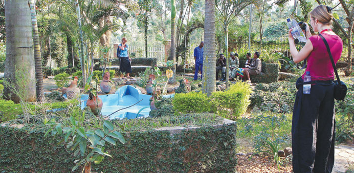 A tourist takes a picture at the Rwanda Genocide memorial in Kigali.