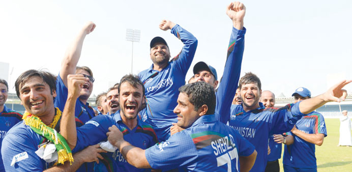 The Afghanistan team celebrate their qualification for the 2015 ICC World Cup after beating Kenya in the UAE yesterday.