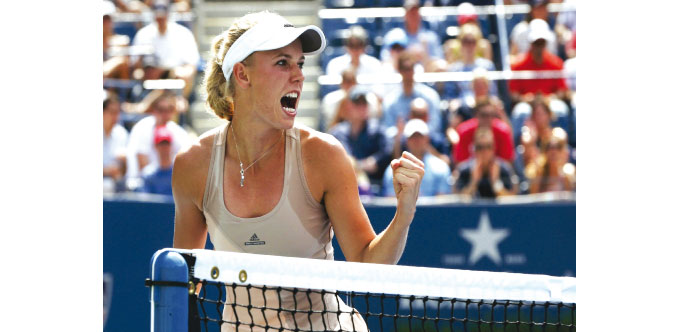 Caroline Wozniacki of Denmark celebrates a point against Maria Sharpova of Russia during their US Open match in New York yesterday..