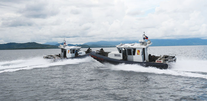 Members of Philippine Maritime police special boat unit, riding on US-made gun boats, manoeuvre as they simulate an apprehension of poachers during a 