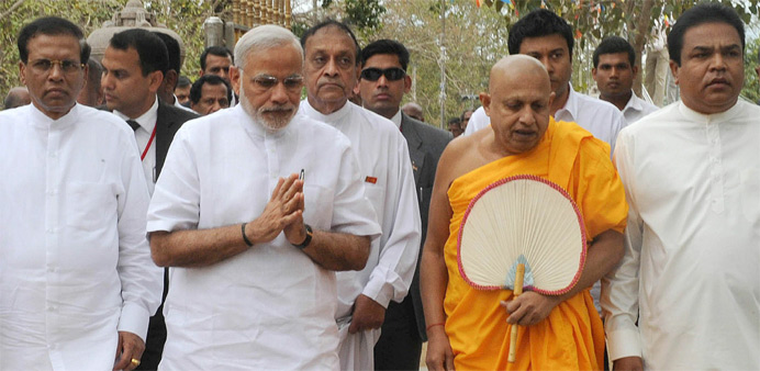 Indian Prime Minister Narendra Modi (2L) and Sri Lankan President Maithripala Sirisena (L) offer prayers at the Sri Maha Bodhi Tree in Anuradhapura.