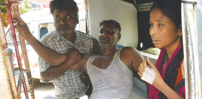 Pakistani relatives shift a heatstroke victim to a government hospital in Karachi yesterday. More than 1,000 people have died as a result of days of s