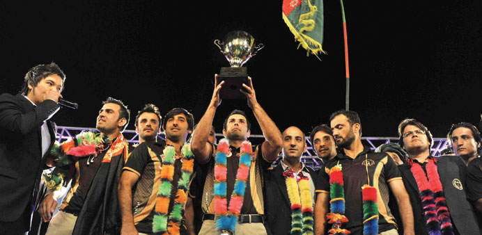 Afghan cricket team captain Mohammad Nabi (C) poses with the ACC Cup after the team arrived in Kabul yesterday. (AFP)