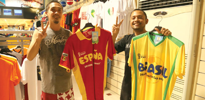 Football fans displaying the jerseys  of their favourite teams at a hypermarket yesterday. 