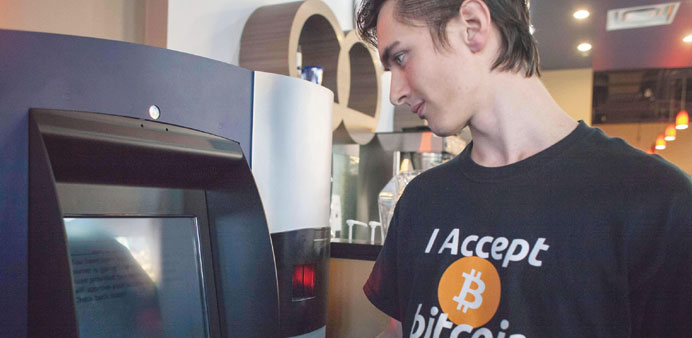    A man uses the worldu2019s first bitcoin ATM yesterday at Waves coffee shop in Vancouver. The ATM, named Robocoin, allows users to buy or sell the digi