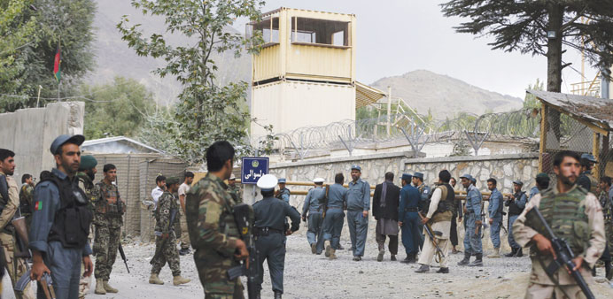 Afghan forces at the main gate of Paghman district compound after a suicide bomb attack yesterday.