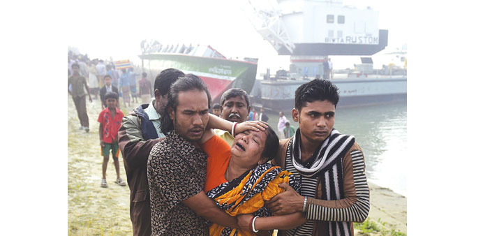 Bangladesh residents react after finding the body of a relative following a ferry accident at Paturia, some 70kms east of Dhaka, yesterday.