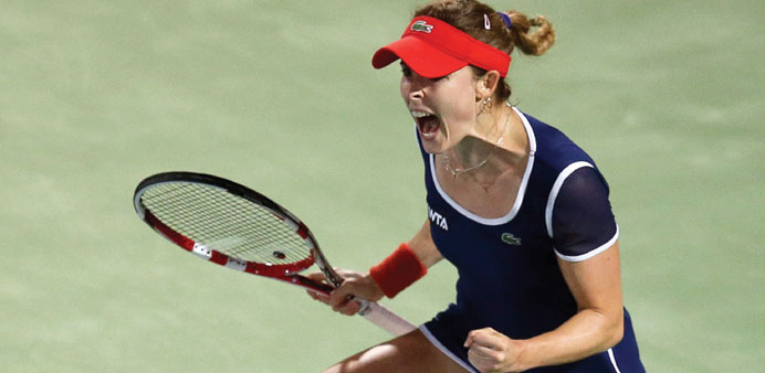 Alize Cornet of France celebrates beating Serena Williams of the