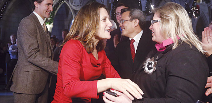 Recently elected Liberal Member of Parliament Chrystia Freeland (centre) is greeted by members of the caucus while arriving with Liberal leader Justin