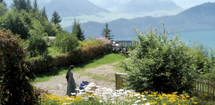 RELAXING: A nun manoeuvres her wheelbarrow through the gardens at Felsentor, a spiritual retreat centre on Switzerlandu2019s Mount Rigi.