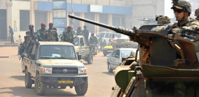 French troops from the 21st Marine Infantry Regiment (RIMA) of the Sangaris Operation conduct a joint patrol with Chadian troops in Bangui yesterday.