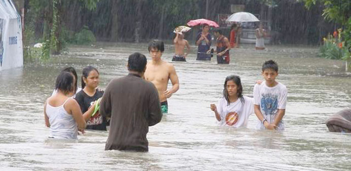  People wade in floods at the height of torrential rains last week.