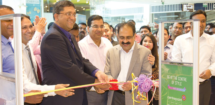 Santosh Pai cutting the ribbon at one of the stores.