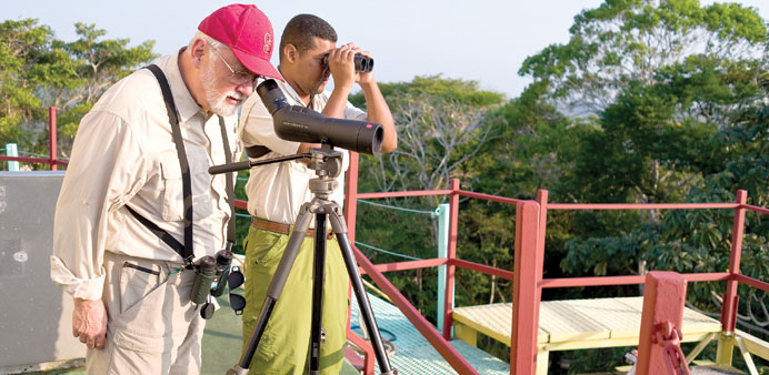 Visitors use optical gear to observe wildlife from atop the Canopy Tower in Panamau2019s Soberania National Park. The eco-lodge is housed in a decommissio